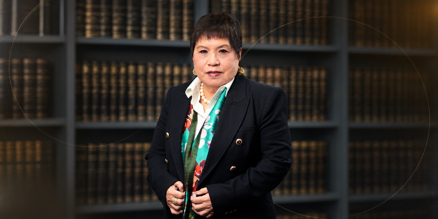 Atty. Lorna Patajo-Kapunan standing in front of shelves of law books