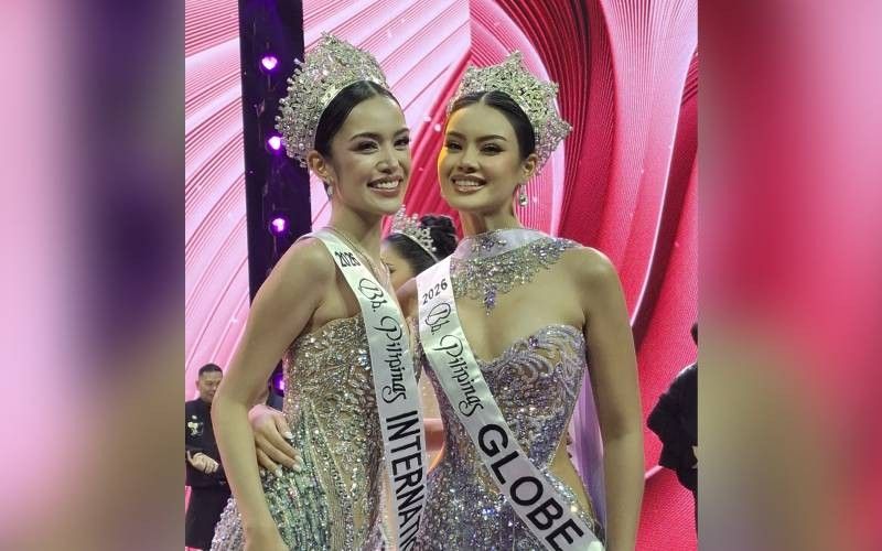Gwendoline Soriano and Sasha-Juli Lacuna smiling in crowns and silver gowns after the Binibining Pilipinas coronation