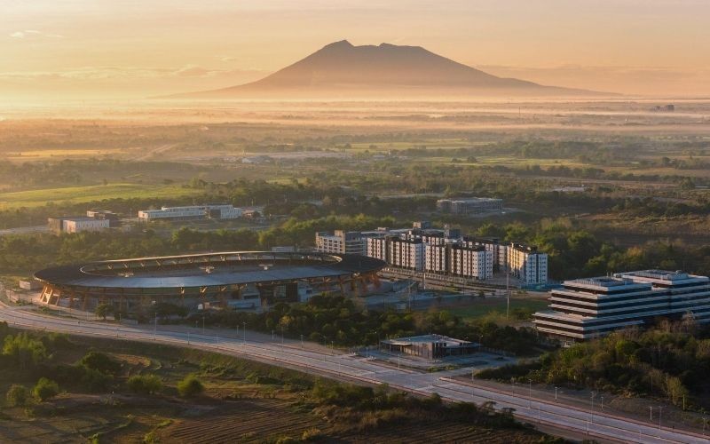 Aerial view of the stadium, buildings, and landscape of New Clark City in Capas, Tarlac